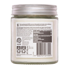 Back of a glass jar with a label featuring text and logos on a white background