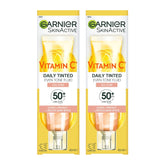 Two bottles of Garnier Vitamin C Daily Tinted Even Tone Fluid on a white background