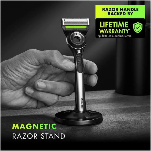 Closeup of GilletteLabs Exfoliating Razor resting on sleek magnetic stand for hygienic storage.