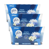 Three Glade candle packages with floral design on a white background
