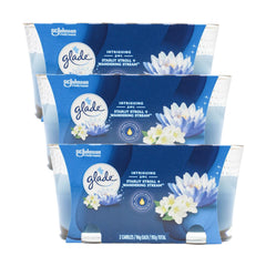 Three Glade candle packages with floral design on a white background