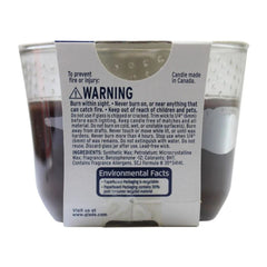 Candle packaging with warning label and environmental facts on a white background