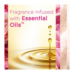 Product packaging with fragrance infused with essential oils text and oil droplet illustration on a pink floral background.