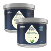 Two Glade Aromatherapy candles with blue labels on a white background