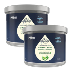 Two Glade Aromatherapy candles with blue labels on a white background