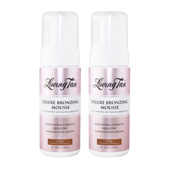 Two bottles of Loving Tan Deluxe Bronzing Mousse on a white background
