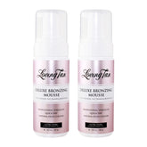 Two bottles of Loving Tan Deluxe Bronzing Mousse on a white background