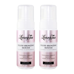 Two bottles of Loving Tan Deluxe Bronzing Mousse on a white background