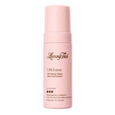 Pink bottle of Loving Tan 2HR Express Self Tanning Mousse on a white background