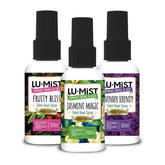 Three bottles of Lu-Mist toilet bowl spray with different scents on a white background