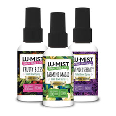 Three bottles of Lu-Mist toilet bowl spray with different scents on a white background