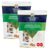 Two packages of Manuka Health Manuka Honey Drops with Propolis, each package contains 250g of lozenges with the brand's logo and product information displayed on the packaging.
