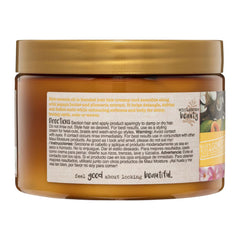 Jar of hair product with a gold lid and label on a white background