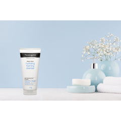 Neutrogena Deep Clean Foaming Cleanser displayed with flowers and towels in a spa-like setting