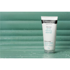 Neutrogena Gentle Foaming Cleanser tube standing on a green surface for a clean, minimalist aesthetic