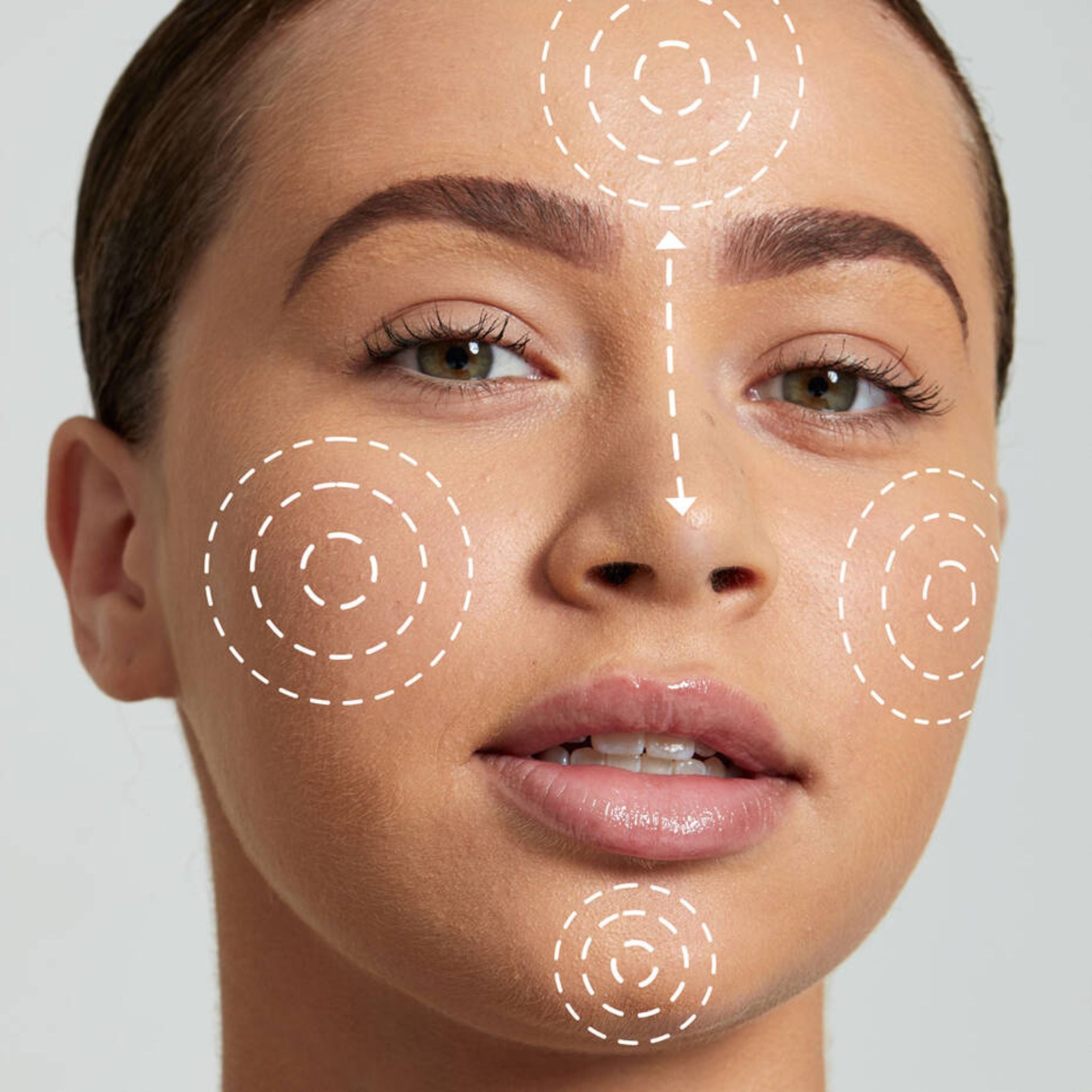 Model applying NYX Angel Veil Primer on face showing even skin coverage before makeup.