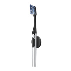 Black and silver electric toothbrush on a white background