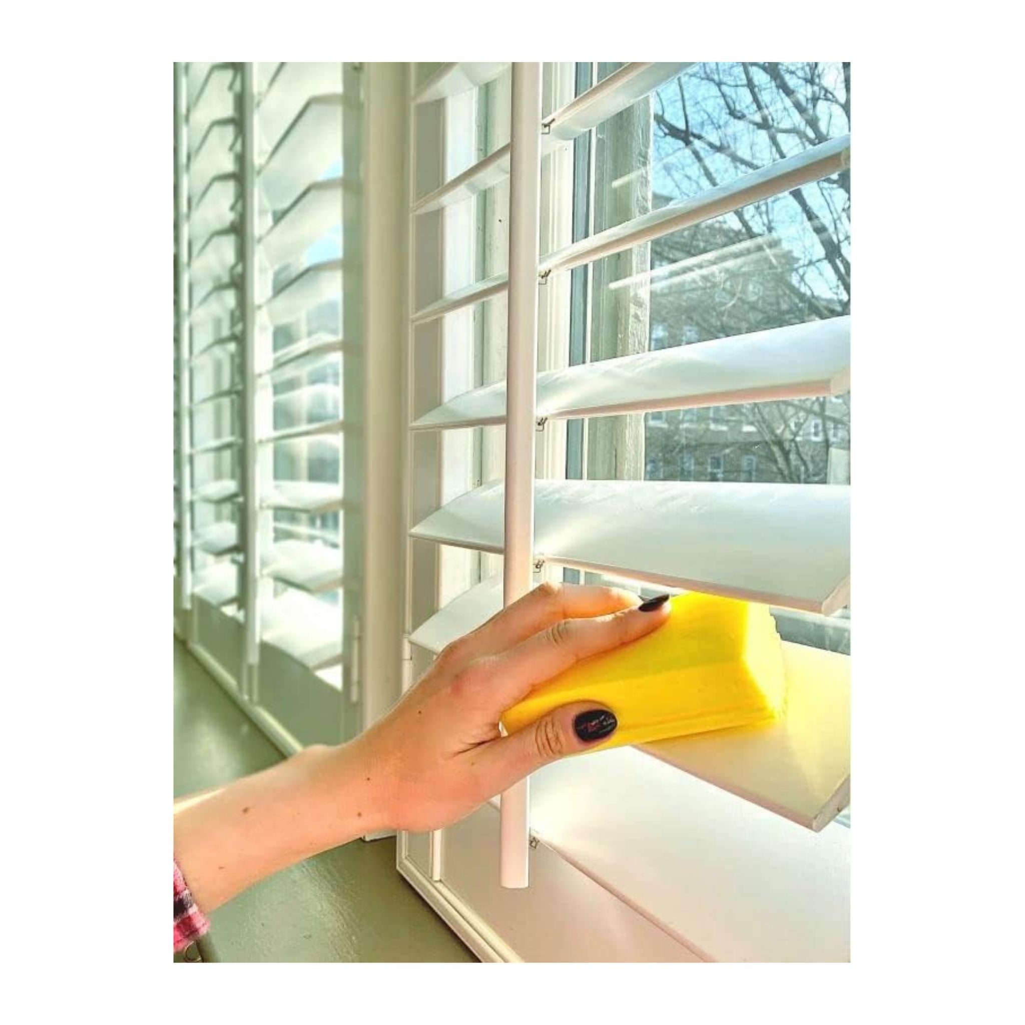 Scrub Daddy Sponge Caddy with smiley face sponges on a kitchen sink background