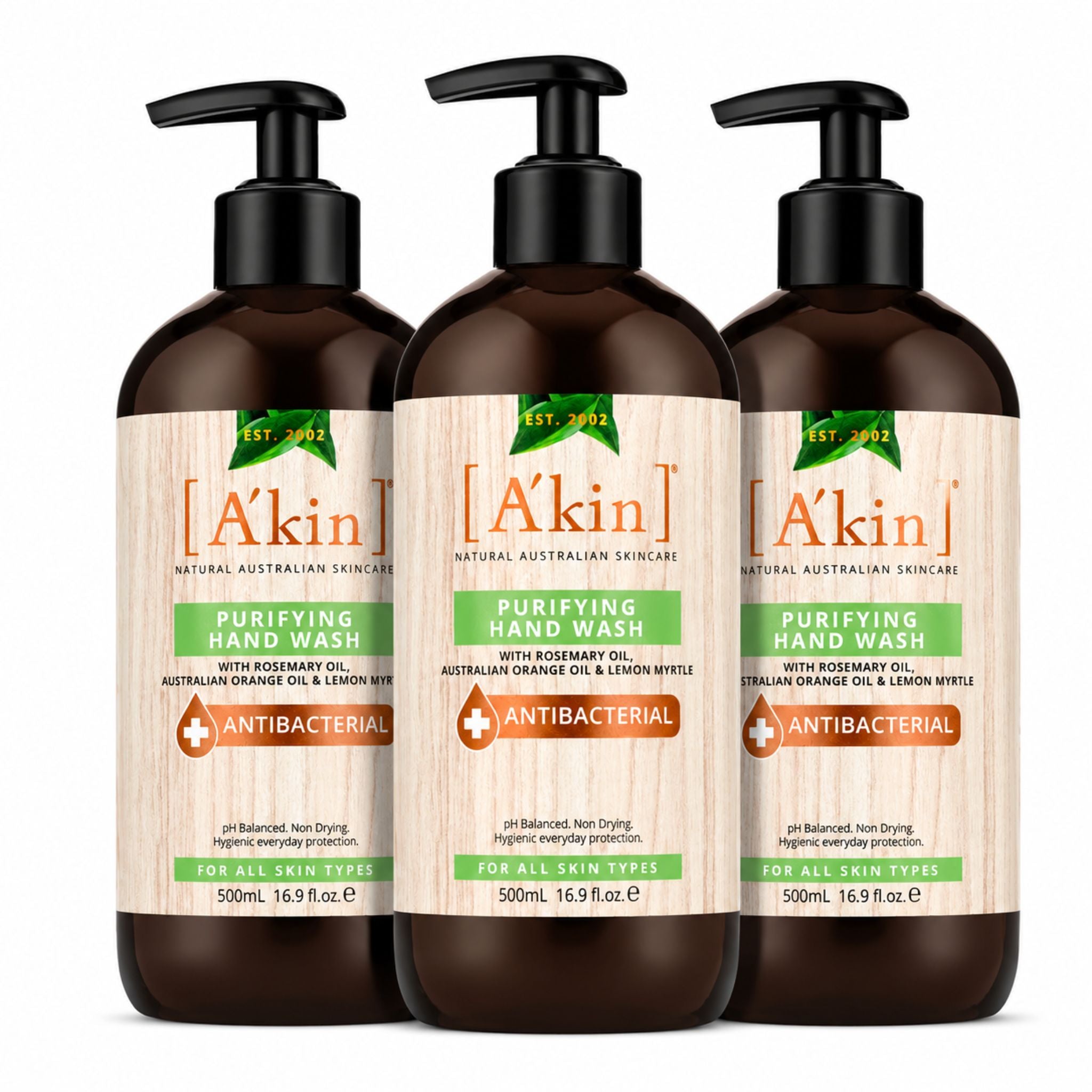 Three bottles of A'kin Purifying Hand Wash on a white background