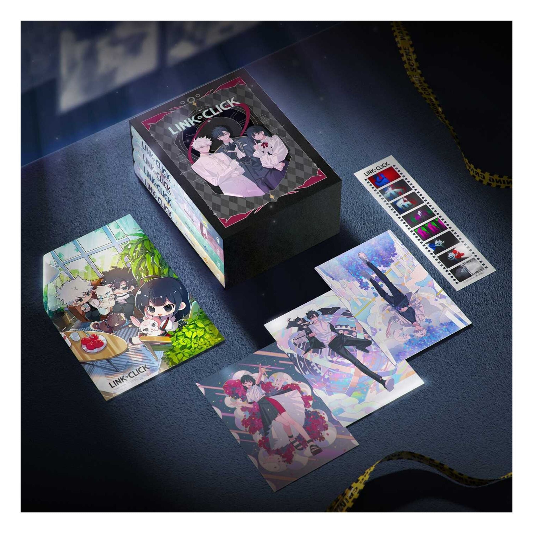 A boxed anime collectible set labeled LINK-CLICK, displayed on a dark surface with several printed cards and a strip of illustrated cards arranged around the box. The packaging and artwork feature anime characters in pastel and colorful illustrations.