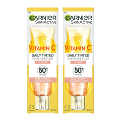 Two bottles of Garnier Vitamin C Daily Tinted Even Tone Fluid on a white background
