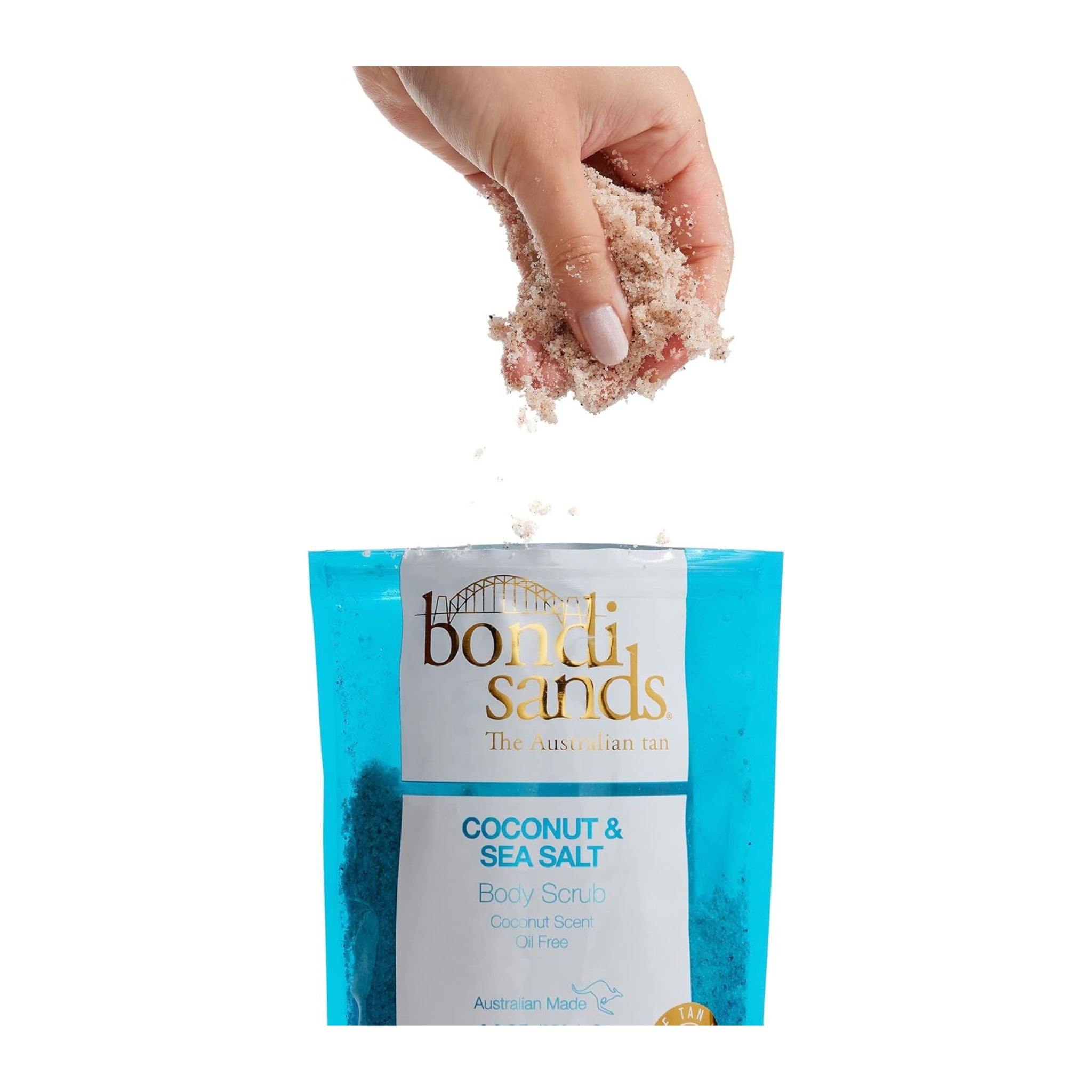 Hand holding a scoop of coconut and sea salt body scrub with a Bontii Sands packaging in the foreground.
