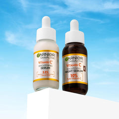 Garnier Vitamin C day and night serums in a lifestyle outdoor setting