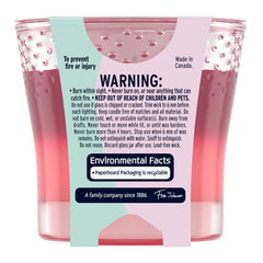 Candle jar with warning label and environmental facts on a white background