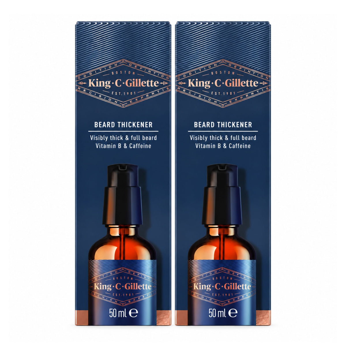 Two identical boxes of King C Gillette Beard Thickener side by side on a plain white background. Each box features a dark blue design with gold lettering and an illustration of an amber bottle with a black cap.