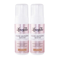 Two bottles of Loving Tan Deluxe Bronzing Mousse on a white background