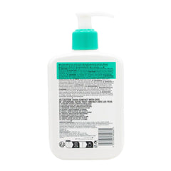 Back view of a white bottle with a green pump and label on a white background