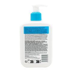 Back view of a bottle with a blue pump and label on a white background